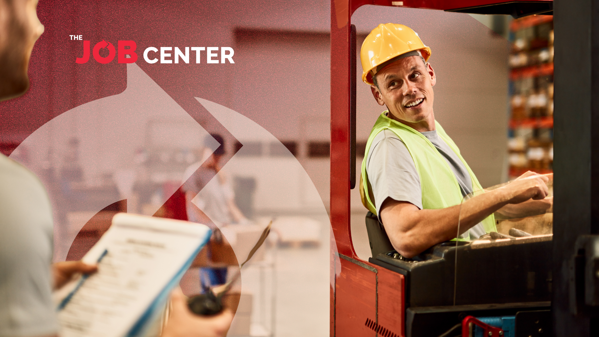 Warehouse worker in safety vest and hard hat operates machinery during peak season