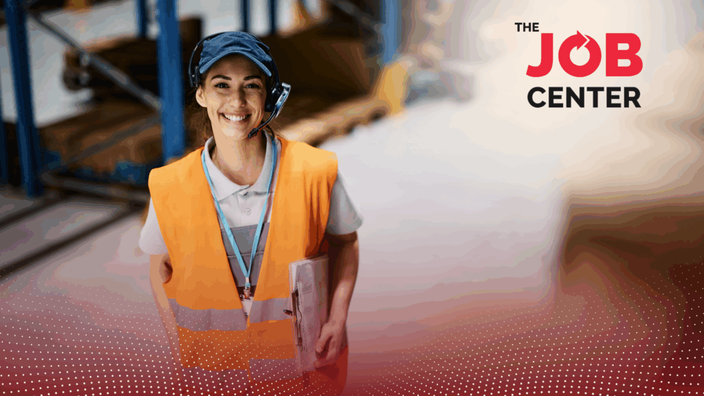 Warehouse worker in logistics stands wearing safety vest and headset, holding a clipboard