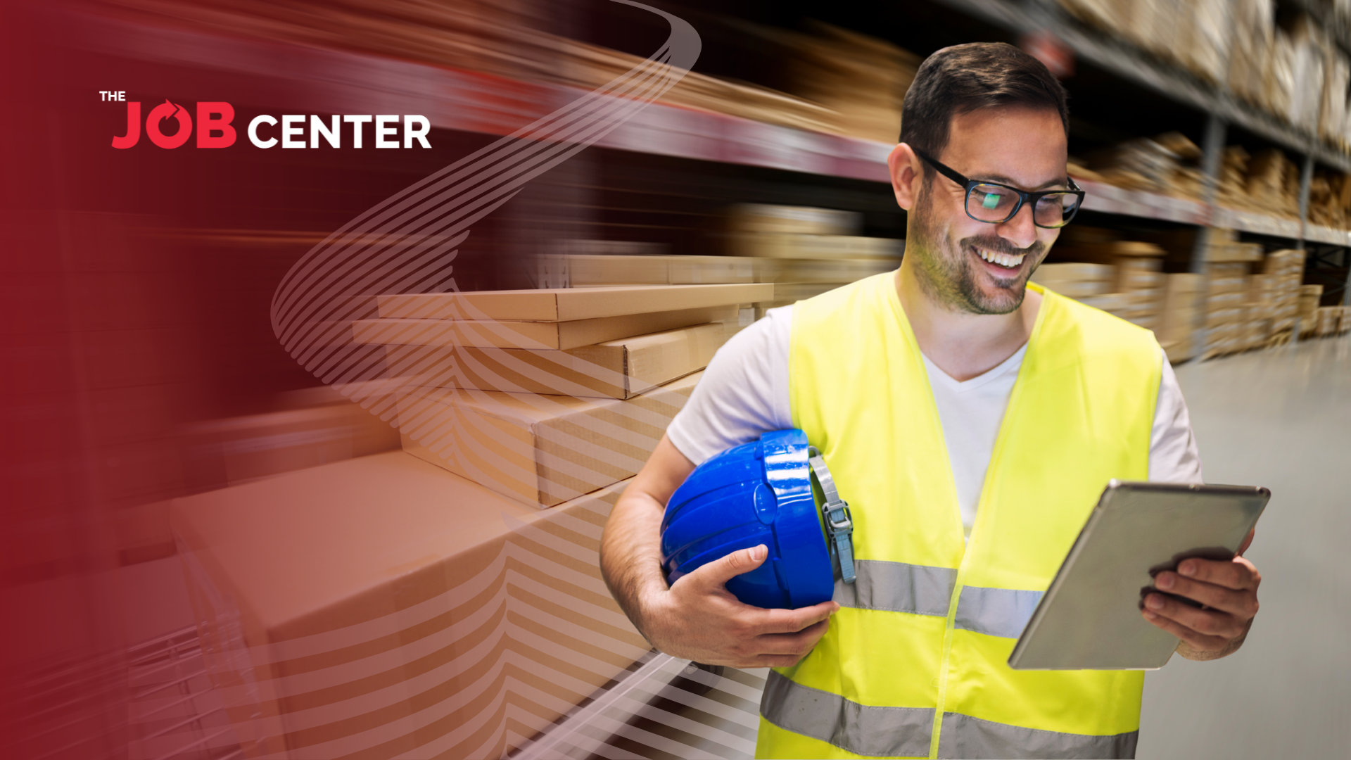 Warehouse worker looks at a clipboard holding a hard hat.