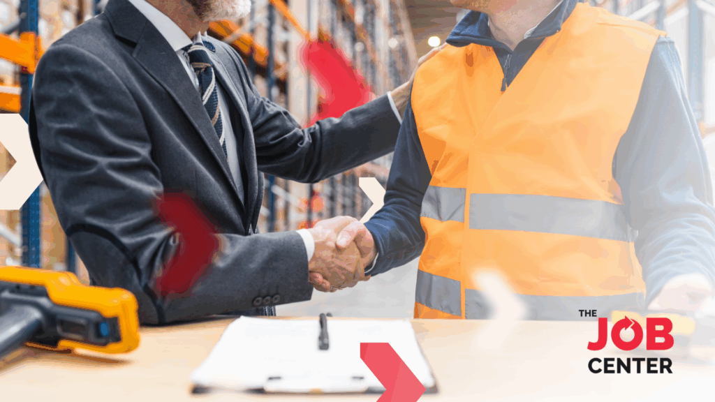 Logistics worker shakes hands with a manager after securing a stable job