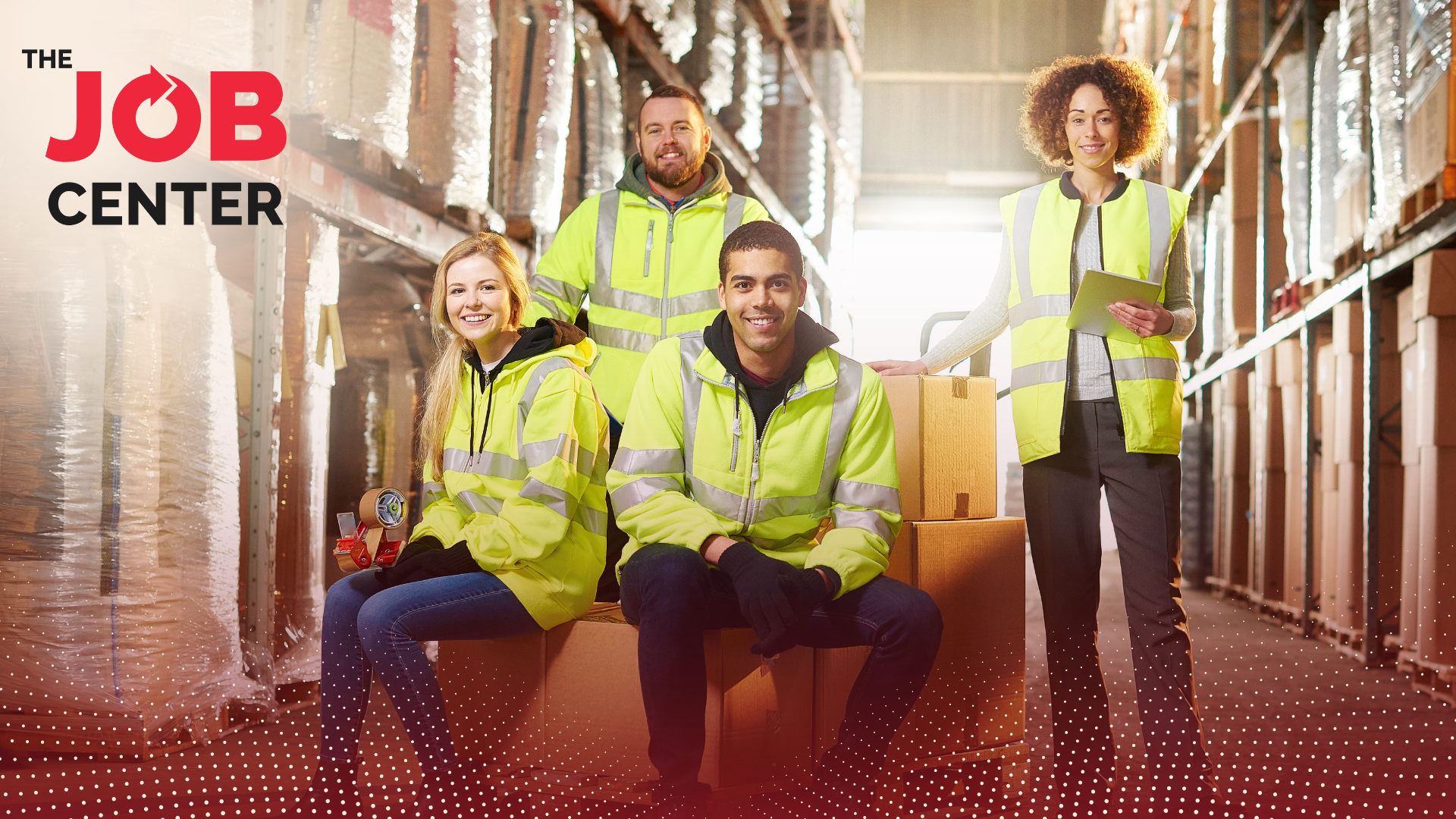 Four warehouse workers smile in a warehouse