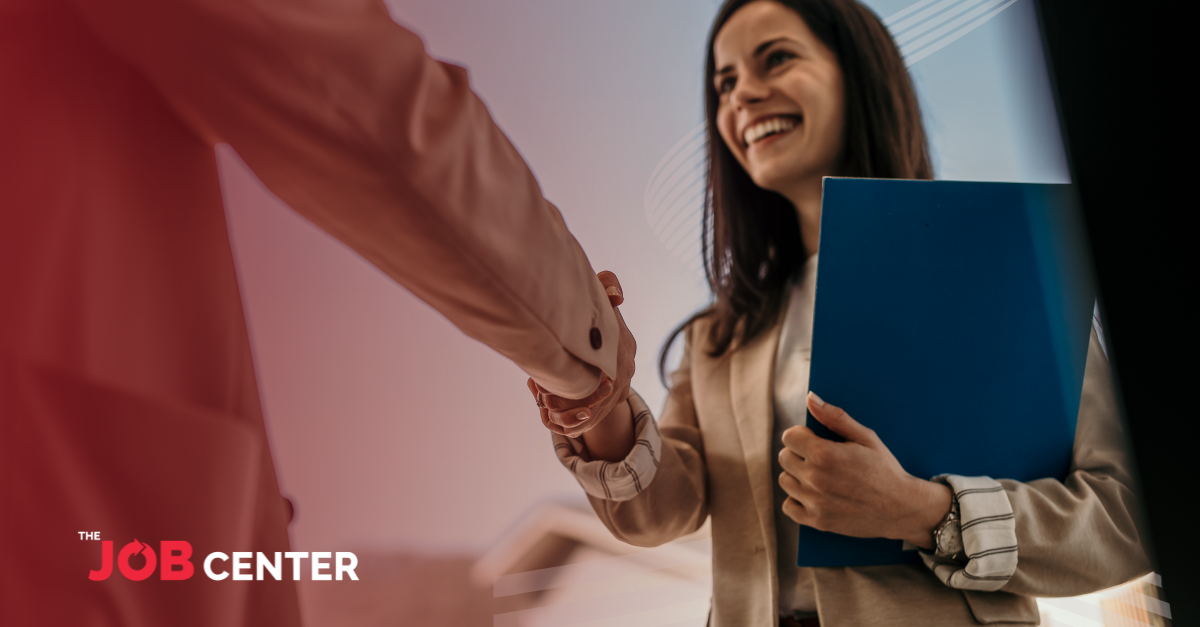 A new hire is welcomed with a handshake